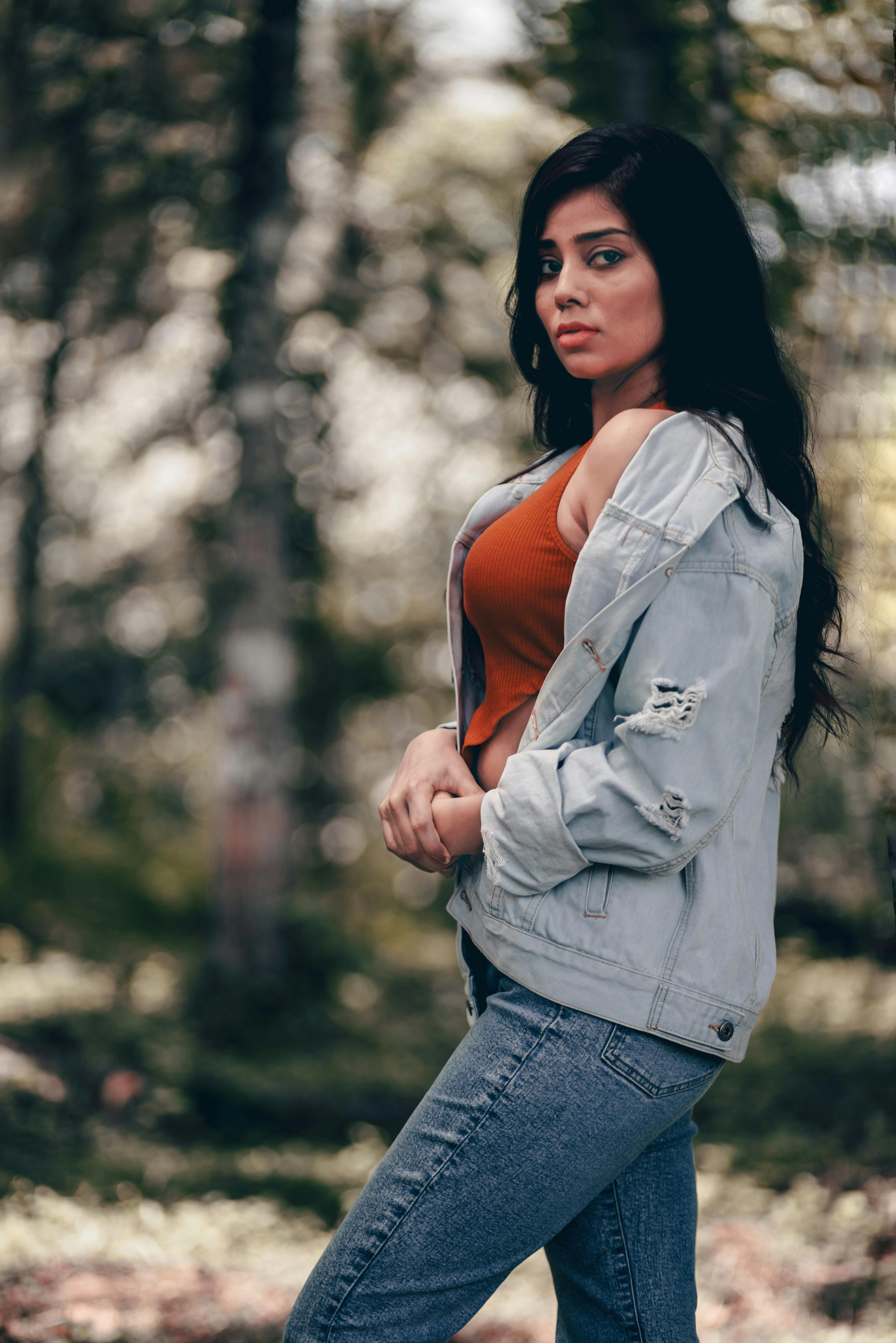 Stylish Beautiful Sexy Model Woman In Trendy Clothes With A Jeans Jacket  Posing Outdoors Near A Building Stock Photo, Picture and Royalty Free  Image. Image 107568955.