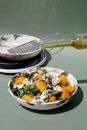 Drop of Olive Oil Added to Salad Made of Diced Pumpkin Lettuce and Cottage Cheese