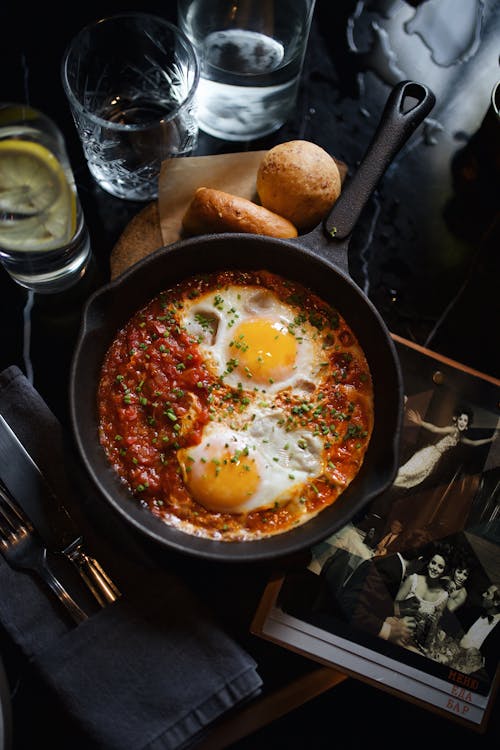 Fried Eggs and Tomato and Herb Souse on Frying Pan