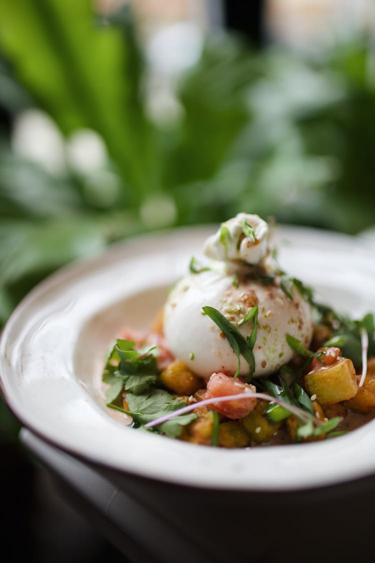 Tasty Green Salad With Poached Egg Served In Saucer