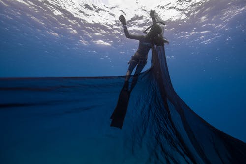 Woman in Blue Dress Under Water