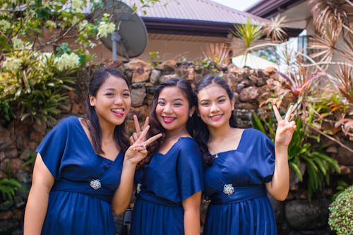 Friends Wearing Blue Dresses Posing Together