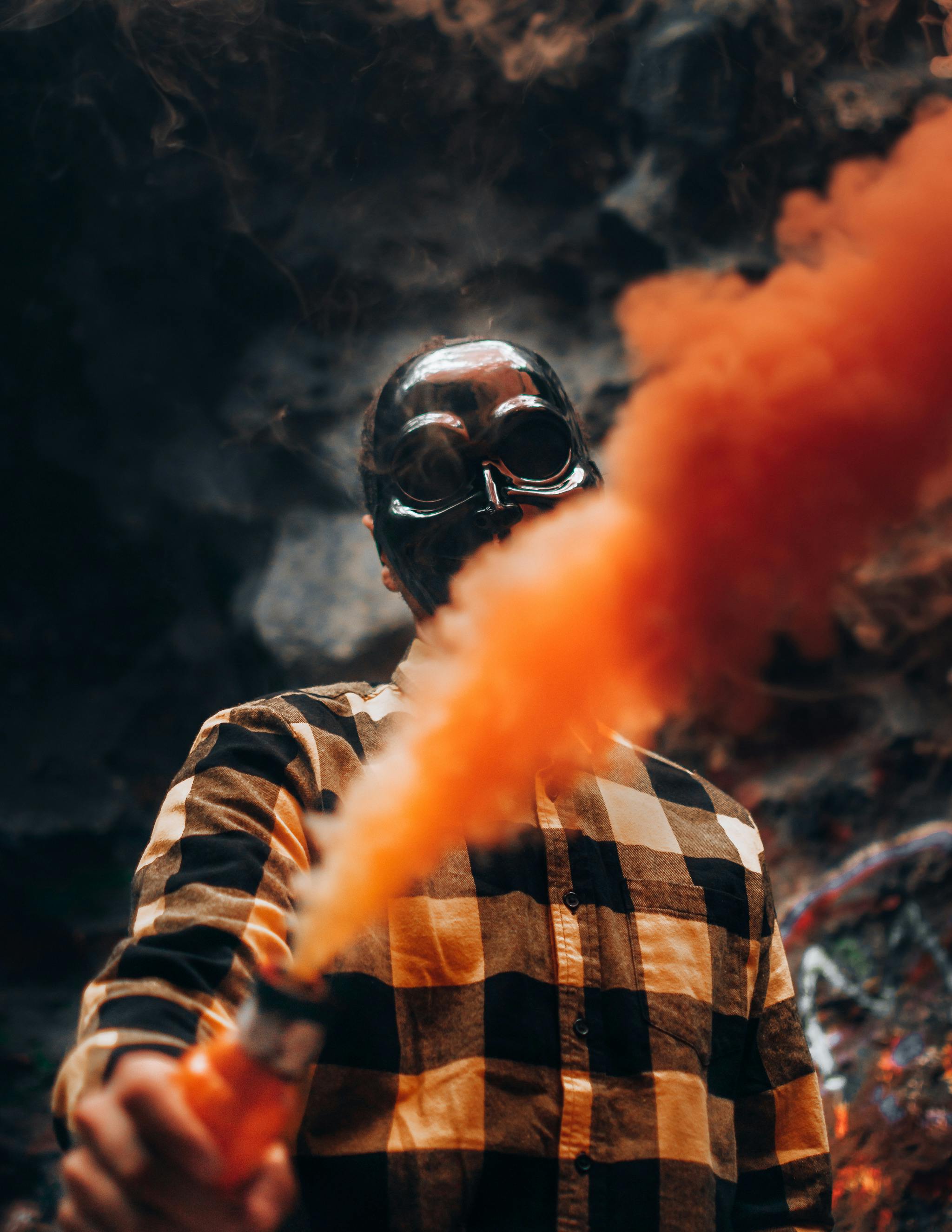 Person Wearing Mask Holding Colored Smoke Bomb · Free Stock Photo