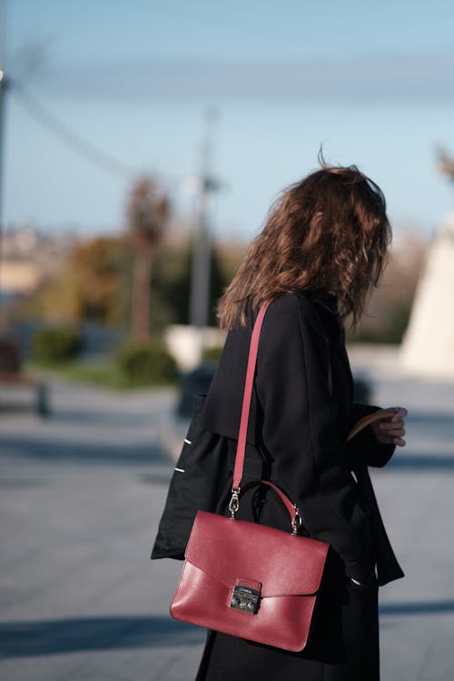 Free Woman Wearing Black Coat Carrying a Shoulder Bag Stock Photo