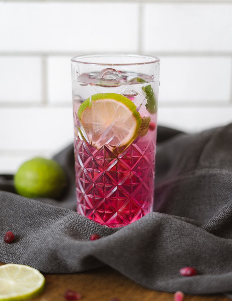 Pink Drink With Lime In Tall Glass