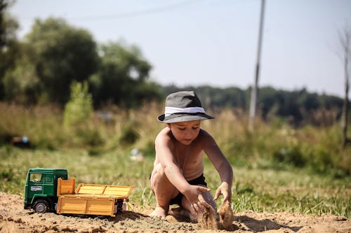 A Boy Playing with Soil