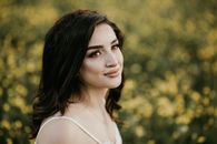 Attractive Brunette Woman in Meadow of Yellow Flowers