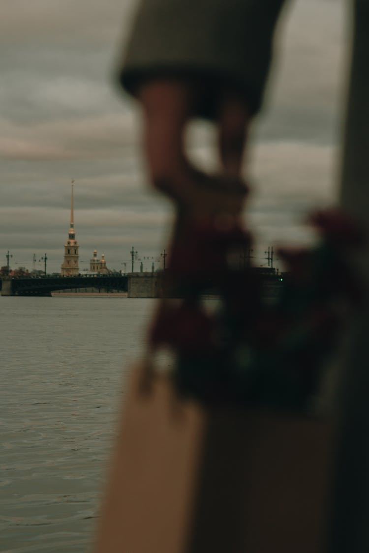 Blurred Close-up On Person On River Shore