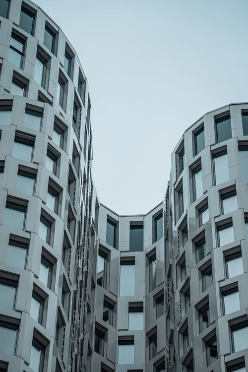 Free A striking modern building with geometric shapes and glass windows, showcasing futuristic architecture. Stock Photo