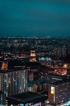 A breathtaking aerial shot of a city's vibrant nighttime skyline, showcasing illuminated skyscrapers.