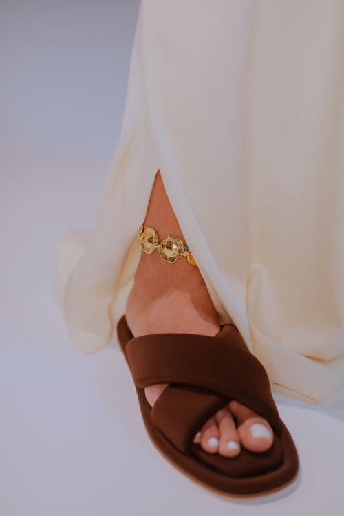 Close-Up Shot of a Person Wearing a Brown Sandal