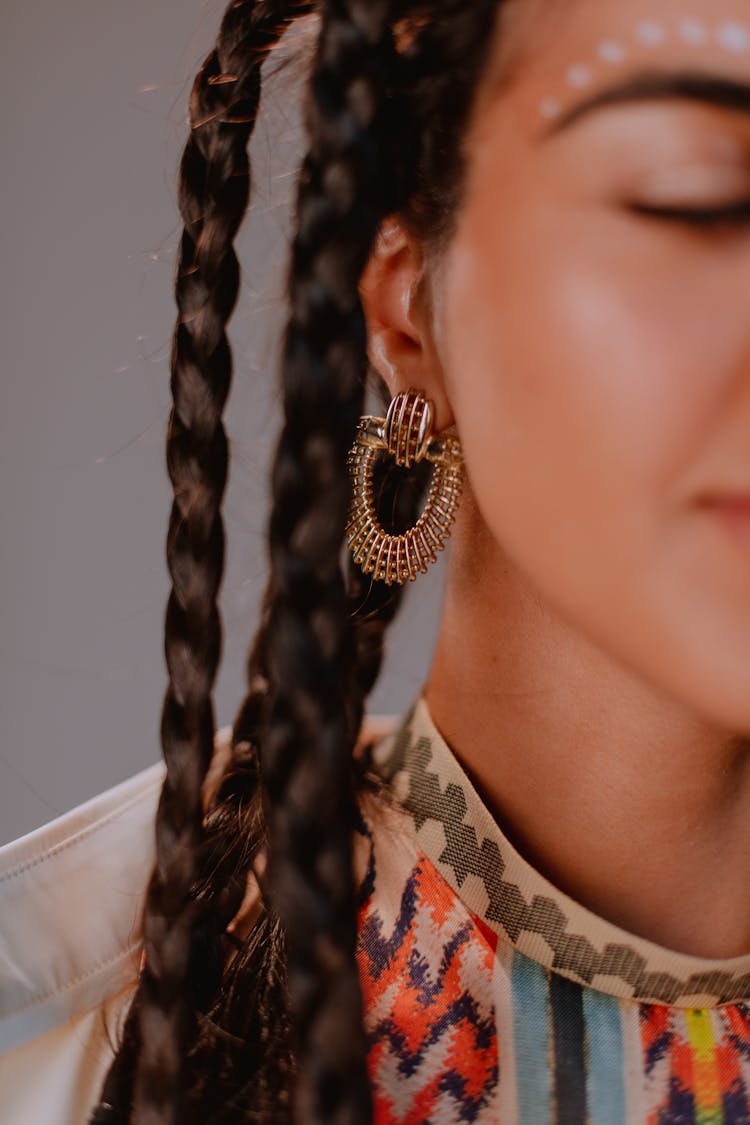 Close-up Photo Of Woman Wearing Gold Earings