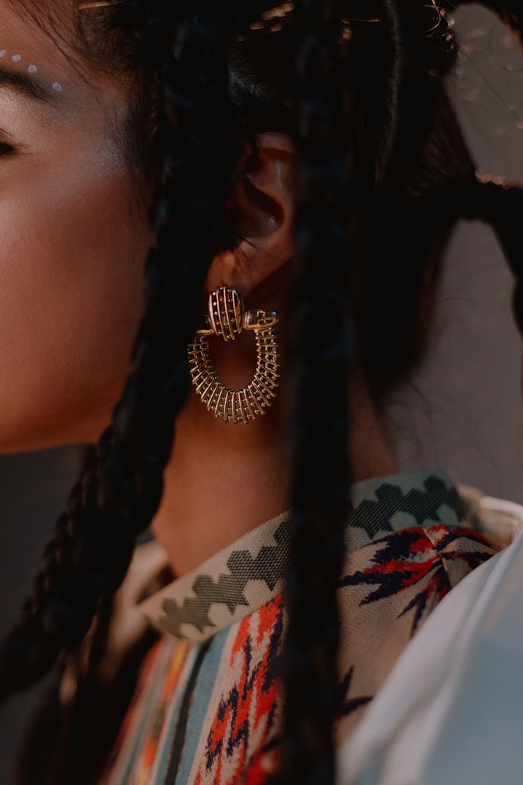 Close-up Photo Of Woman Wearing Gold Earings