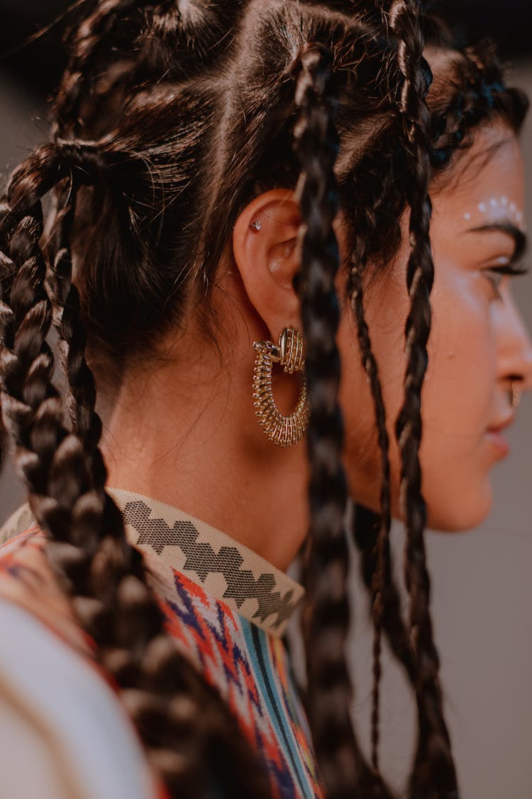 Woman Wearing Gold Earings In Tilt Shift Lens 