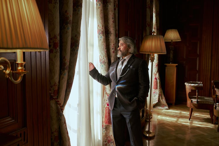 Man Standing In An Luxury Interior And Looking Through The Window