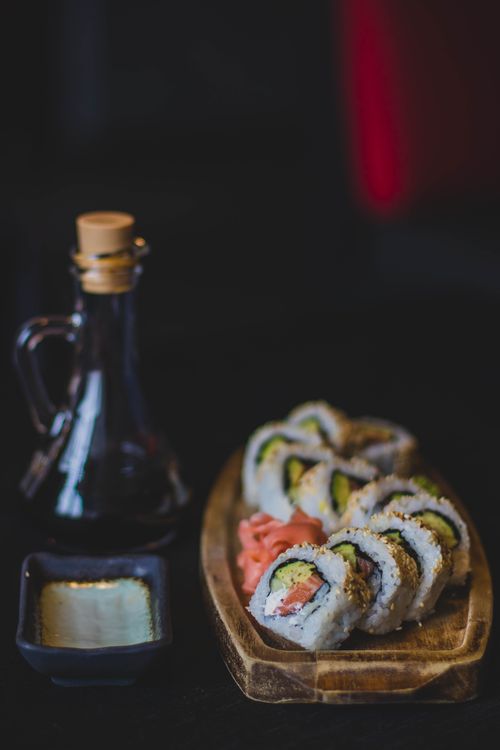 Free Artistic sushi rolls with soy sauce and wasabi in a restaurant setting. Stock Photo