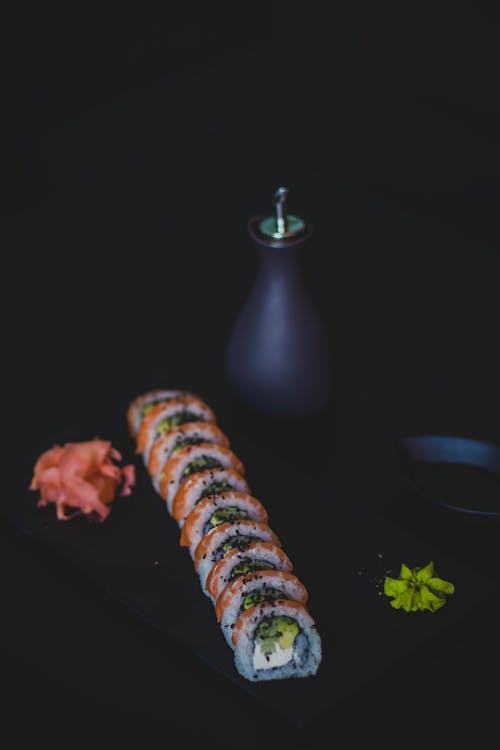 Sushi and Oil Bottle on Top of Table