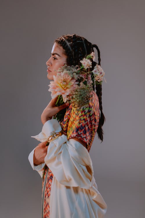 Woman in Traditional Wear holding Flowers