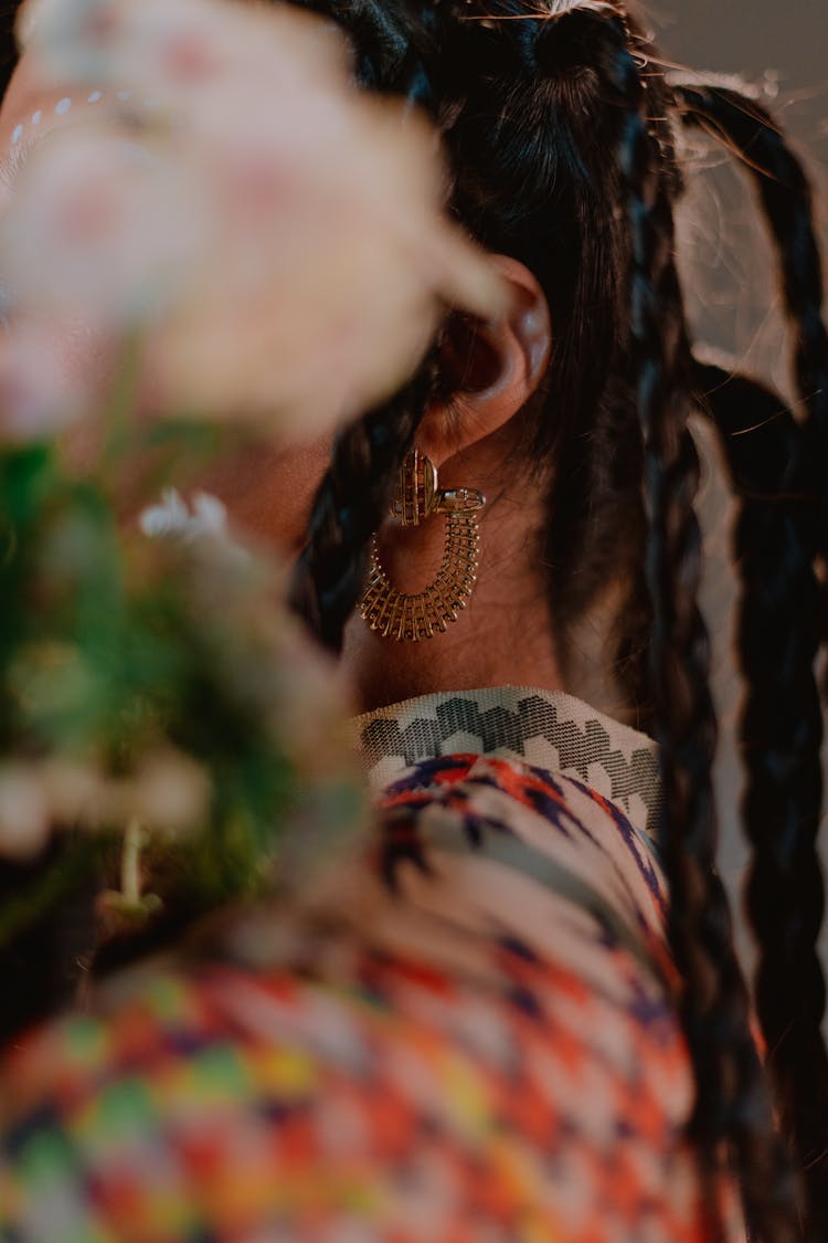 Close-up Photo Of Person With Braided Hair And Gold Earings 