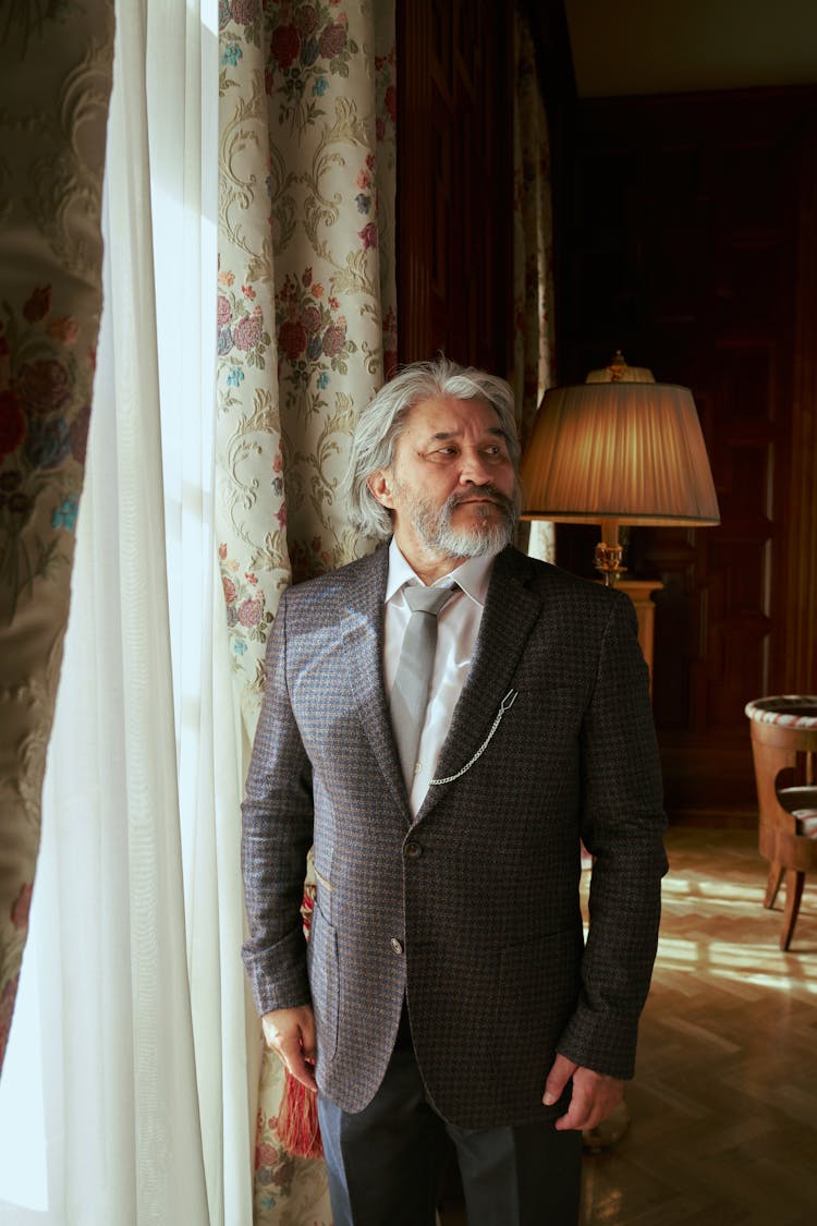 Senior Man Standing In Living Room