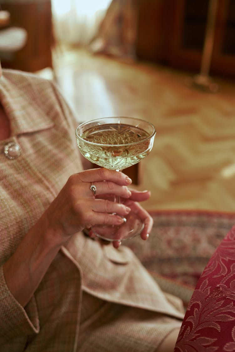 Woman Holding Glass Of White Wine