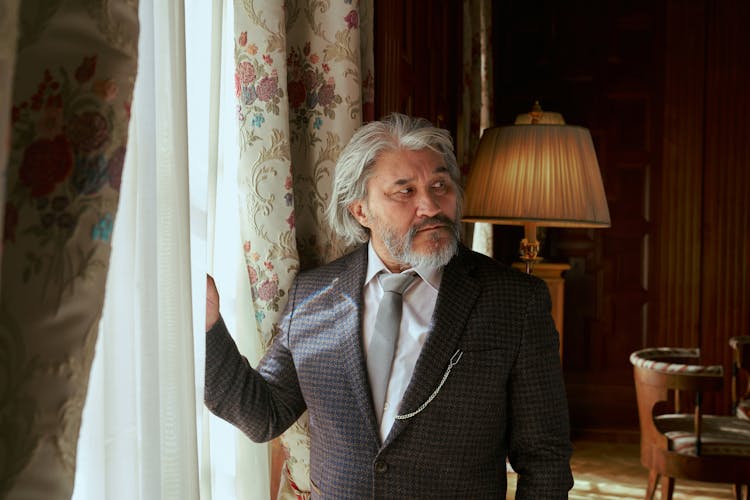 Senior Man Standing In Living Room