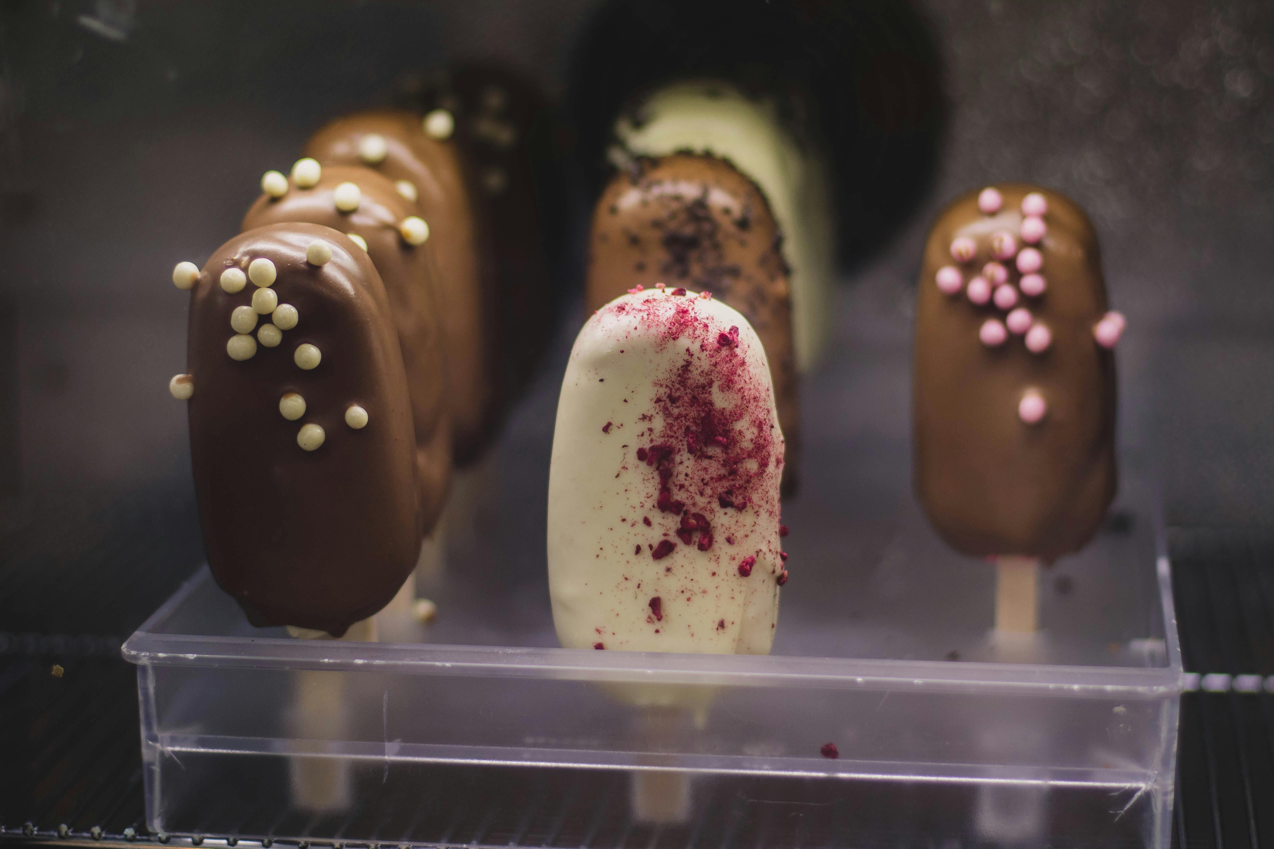 Variety Flavor of Popsicles on Acrylic Case · Free Stock Photo