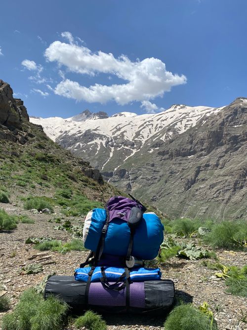 Free Explore breathtaking mountain trails with a backpack under clear blue skies. Stock Photo