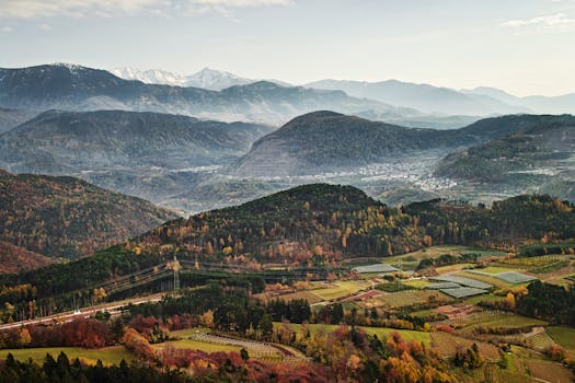 Aerial view of Trentino-Alto Adige mountains and valleys with stunning fall colors.