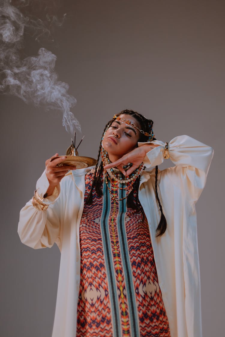 A Woman In White Robe Holding An Incense