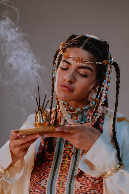 Free A Woman in White Robe Holding an Incense Stock Photo
