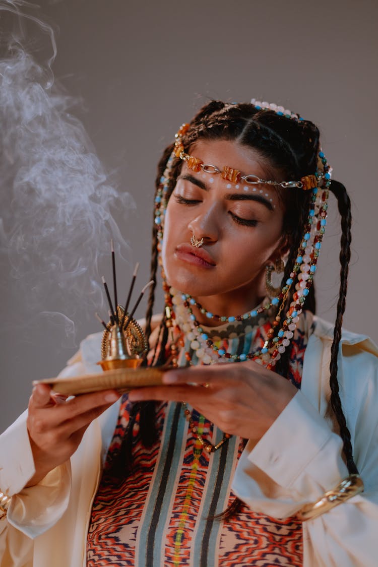 A Woman In White Robe Holding An Incense