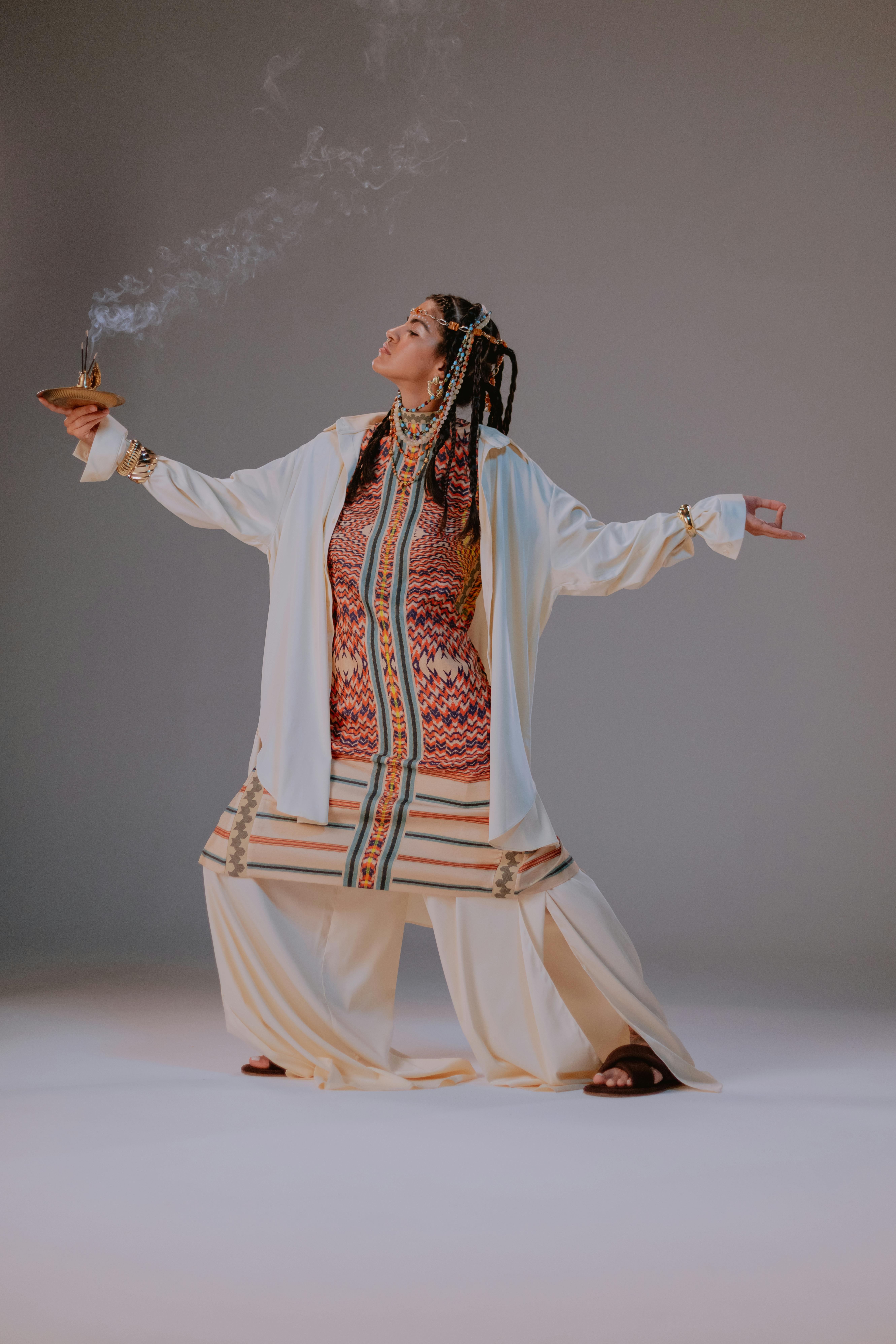 Free A Woman in White Robe Holding an Incense Stock Photo