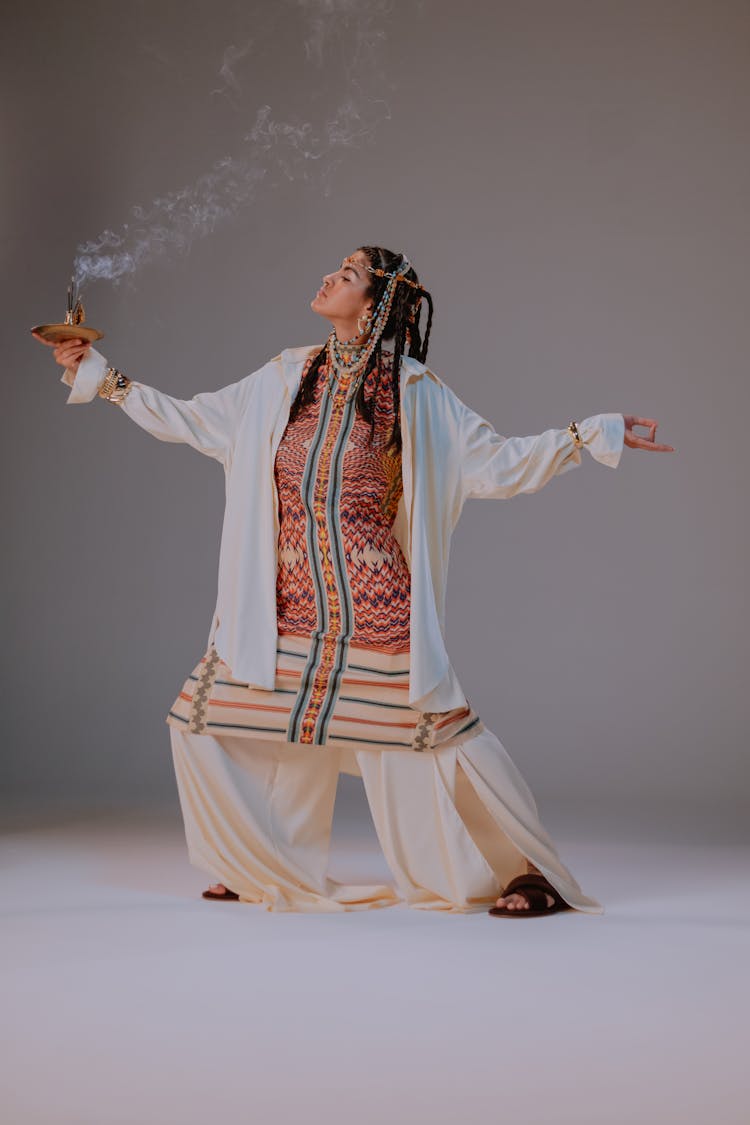 A Woman In White Robe Holding An Incense