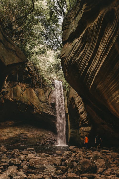 Free Waterfalls Near a Rocky Cave Stock Photo