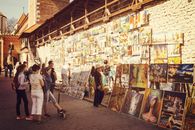 People Looking at Assorted-type Paintings