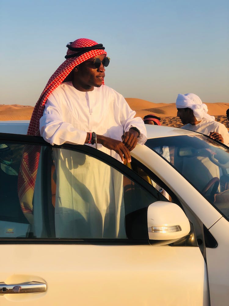 Man Standing From Car On Desert