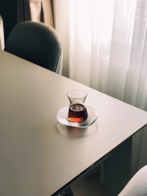 Clear Glass Cup on Brown Wooden Table