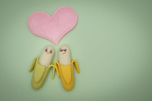 Free Two Green and Yellow Bananas Plastic Figures Stock Photo