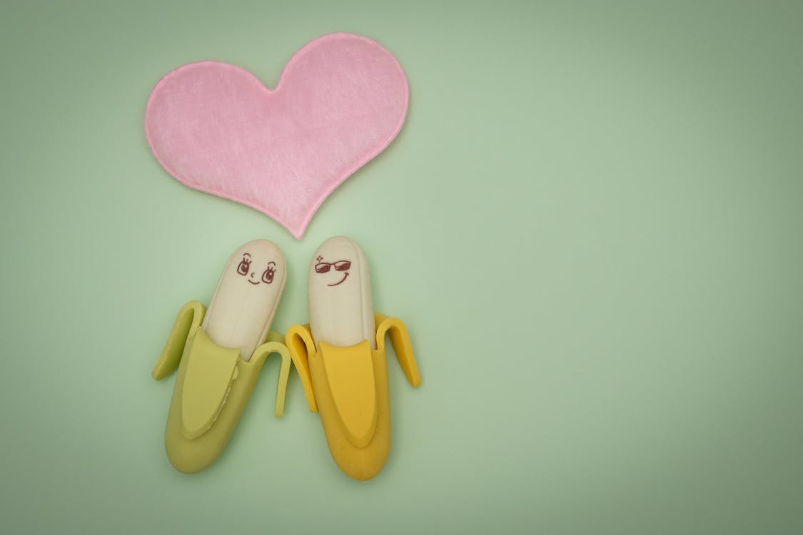 Free Two Green and Yellow Bananas Plastic Figures Stock Photo