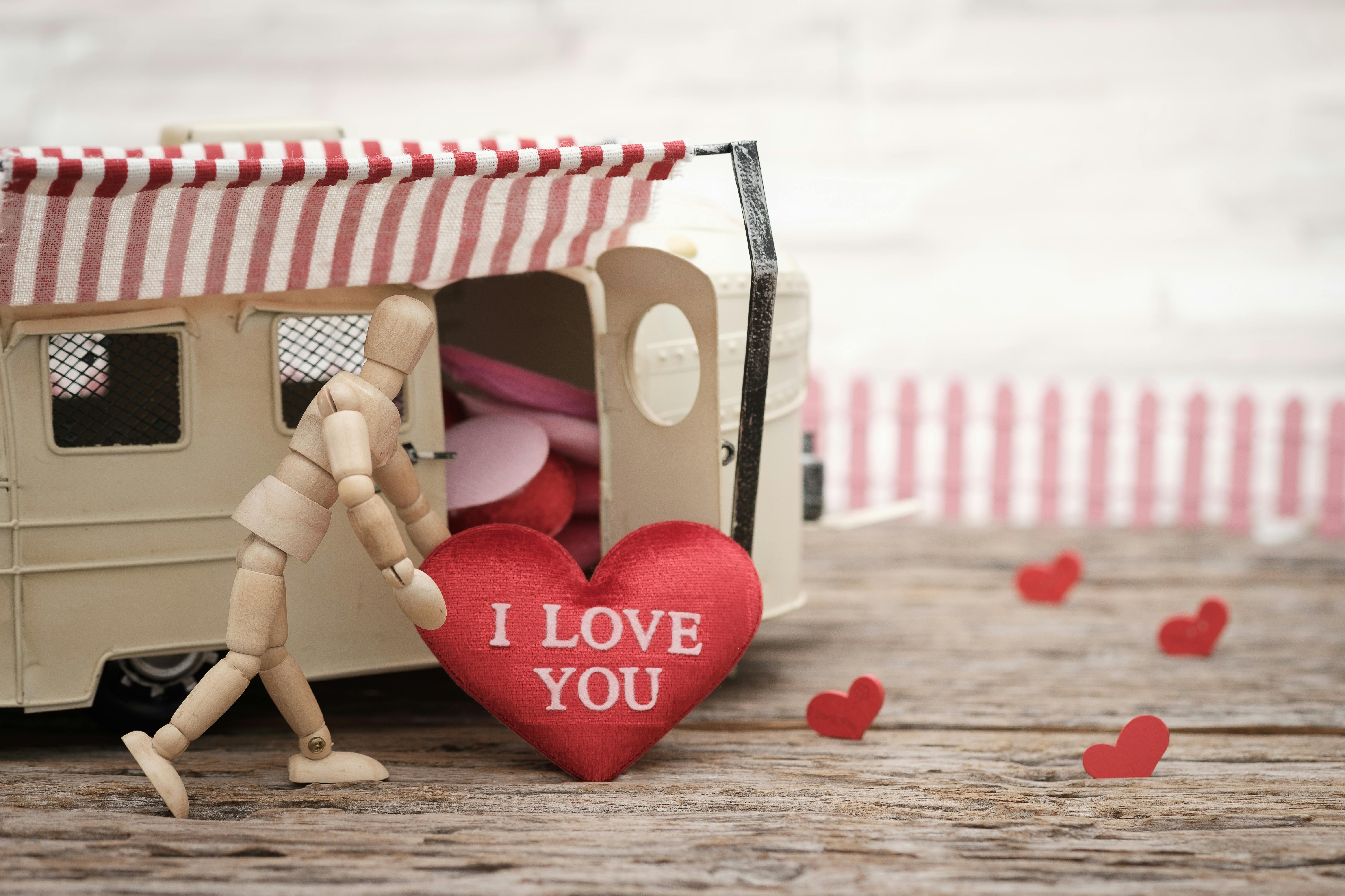 red heart pillow with i love you text