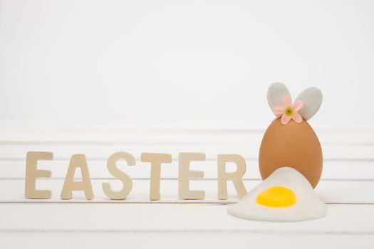 A decorative Easter egg with bunny ears and flower, perfect for holiday celebrations and creative springtime designs.