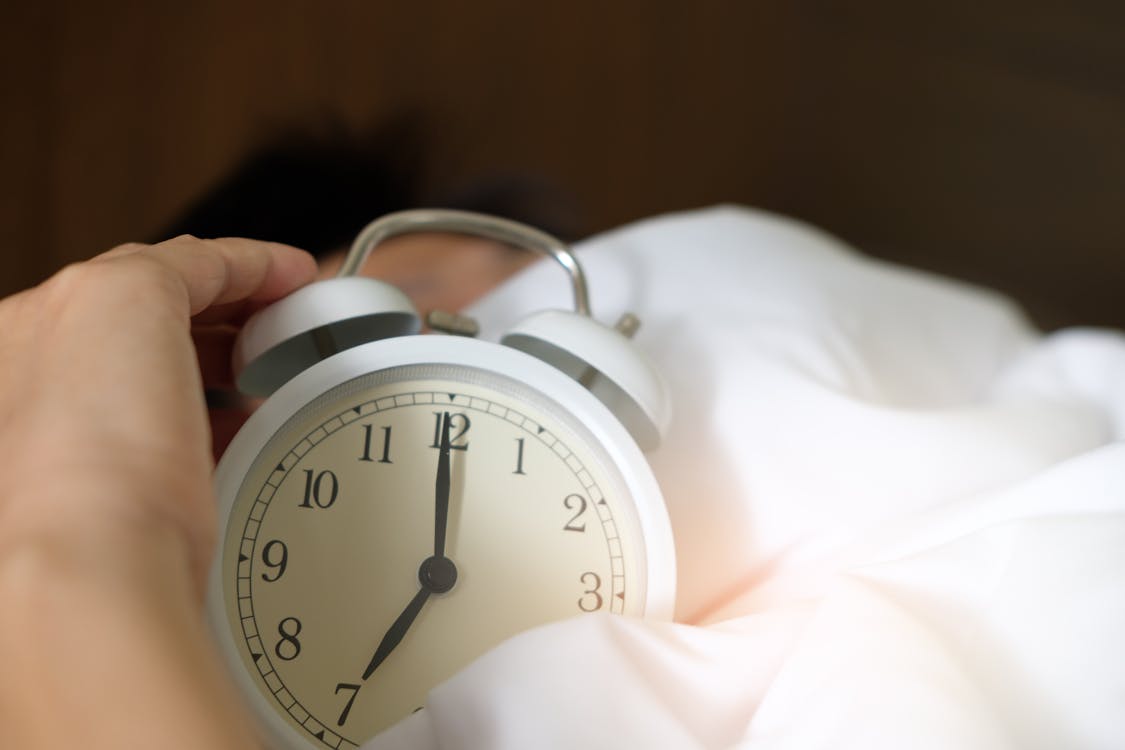 Free Photo of Person Holding Alarm Clock Stock Photo