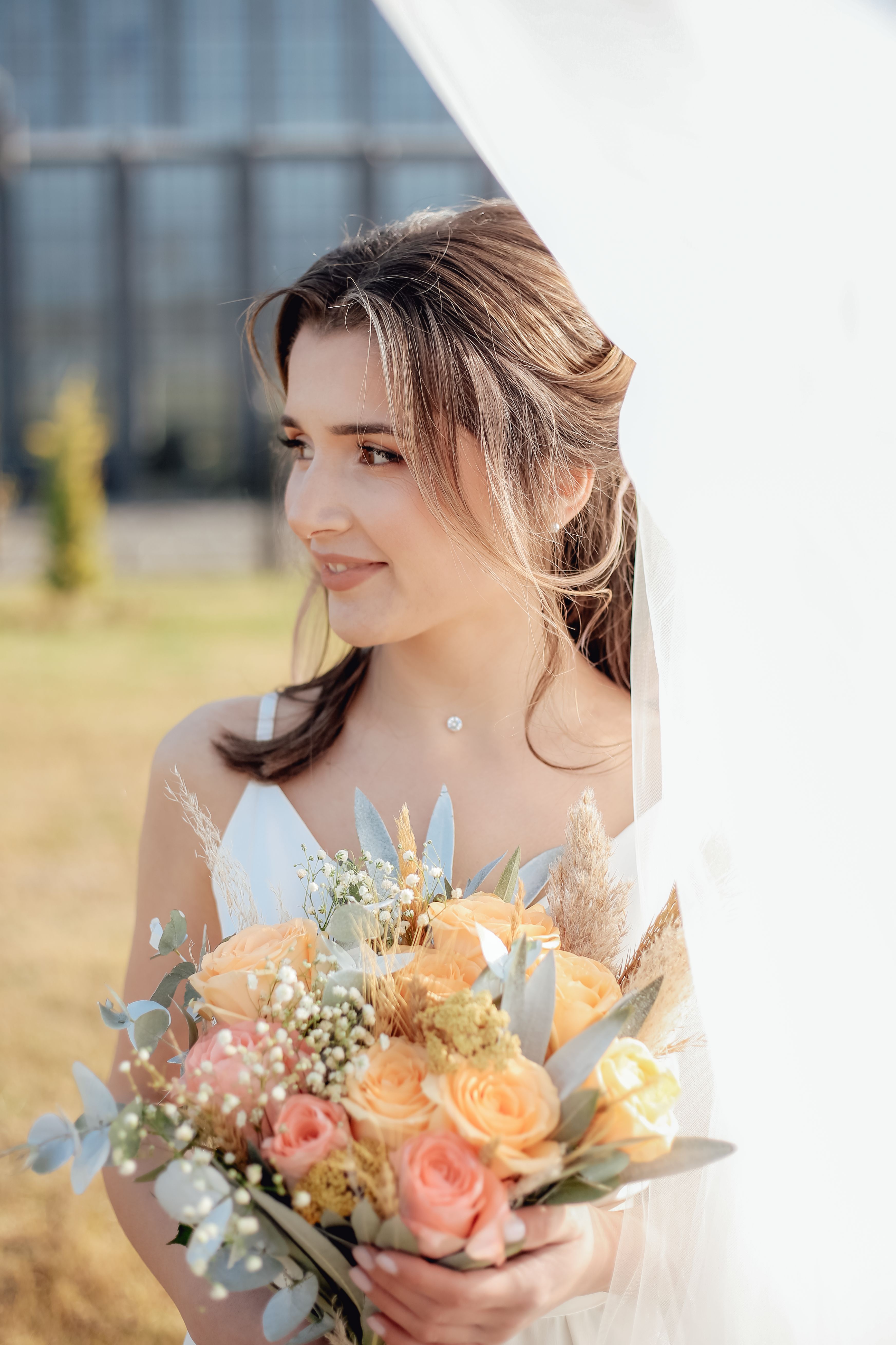 Woman in White Floral Dress Holding Bouquet of Flowers · Free Stock Photo