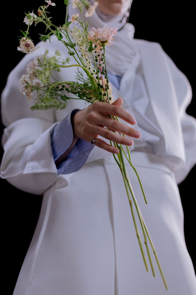 Woman In White Dress Holding Flowers