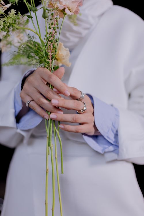 Free Close-up of hands holding a delicate bouquet with pastel flowers, perfect for spring themes. Stock Photo
