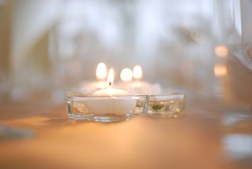 Free Soft focus image of lit candles creating a warm and intimate atmosphere, perfect for weddings or romantic settings. Stock Photo