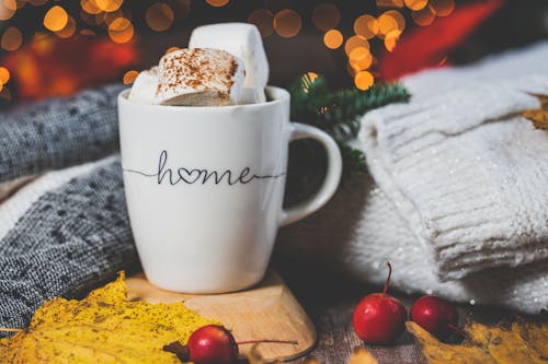 Cup with Marshmallows Beside Red Cherries