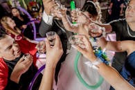 People Holding Drinking Glasses With Green Straw