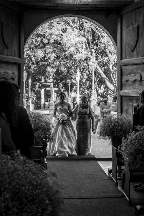 Free Bride with Her Mother Walking on the Doorway Stock Photo
